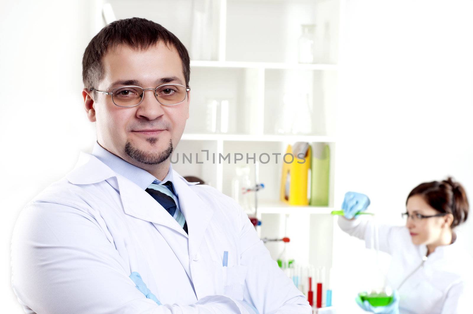 Portrait of the doctor, on a back background work colleagues in a medical office