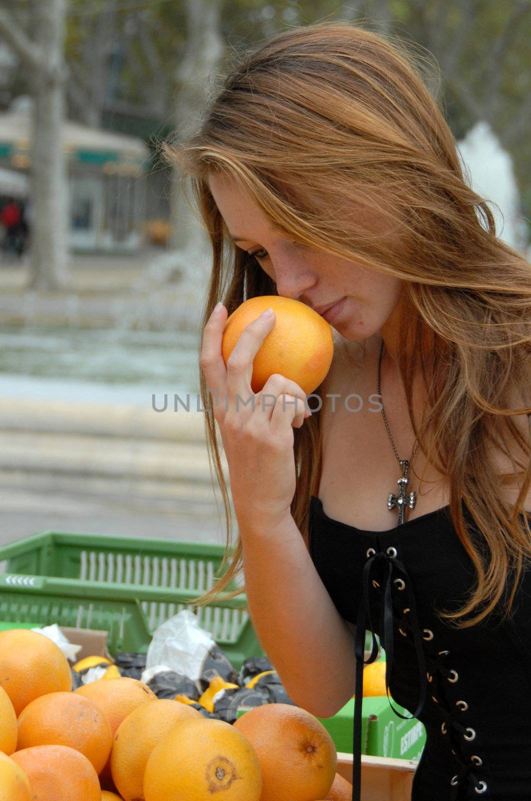 young teen in a market in montpellier for buy citrus fruits
