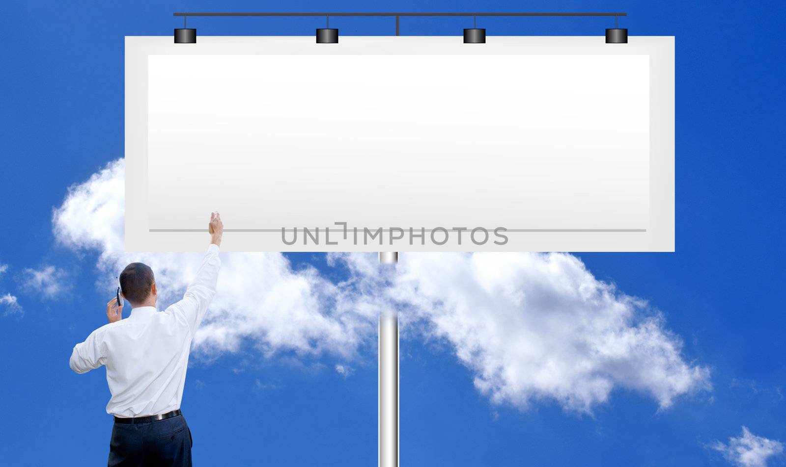 The successful businessman against a publicity board and the bright blue cloudy sky