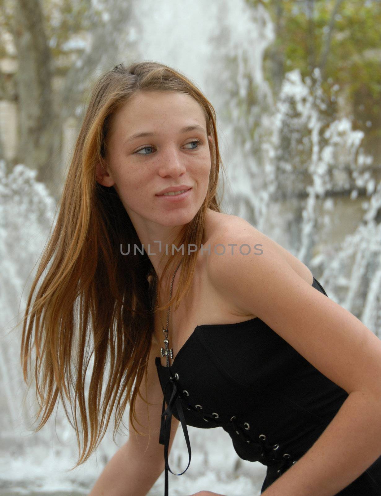 young teenager near a fountain: beautiful pretty girl

