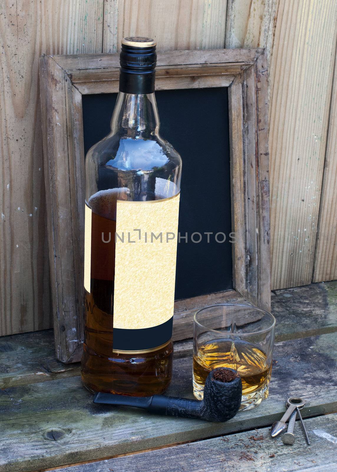 still life with bottle of whiskey and a glass