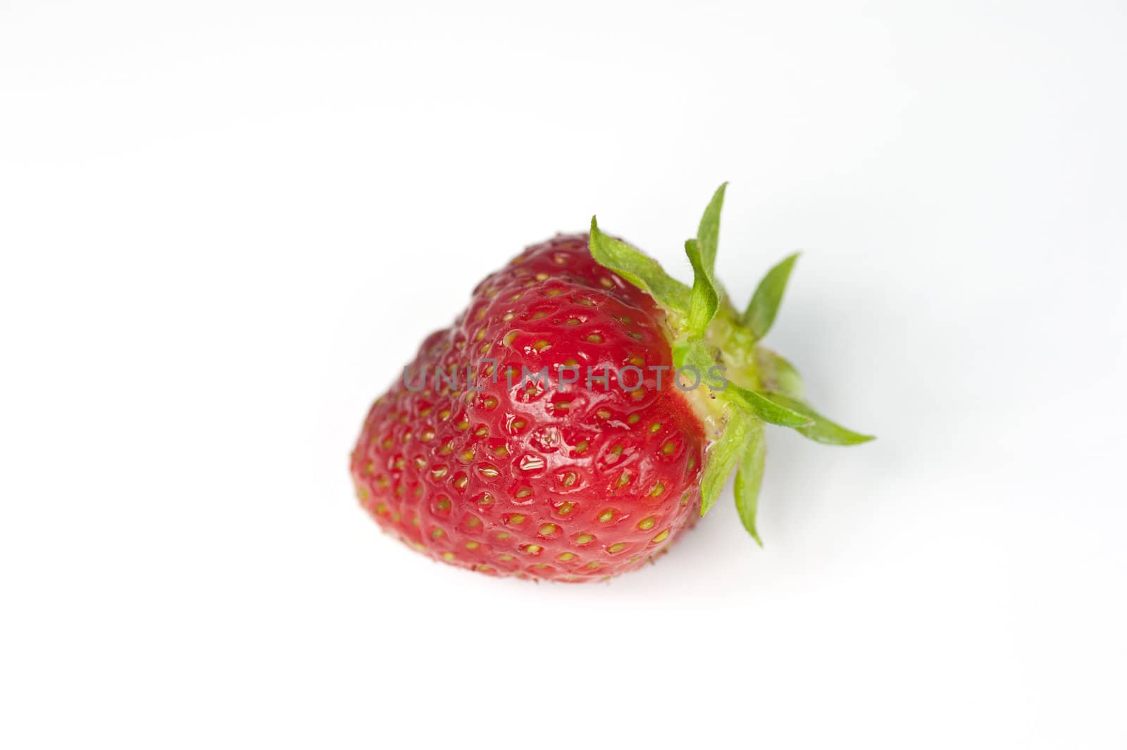 Closeup of a single strawberry on a white background