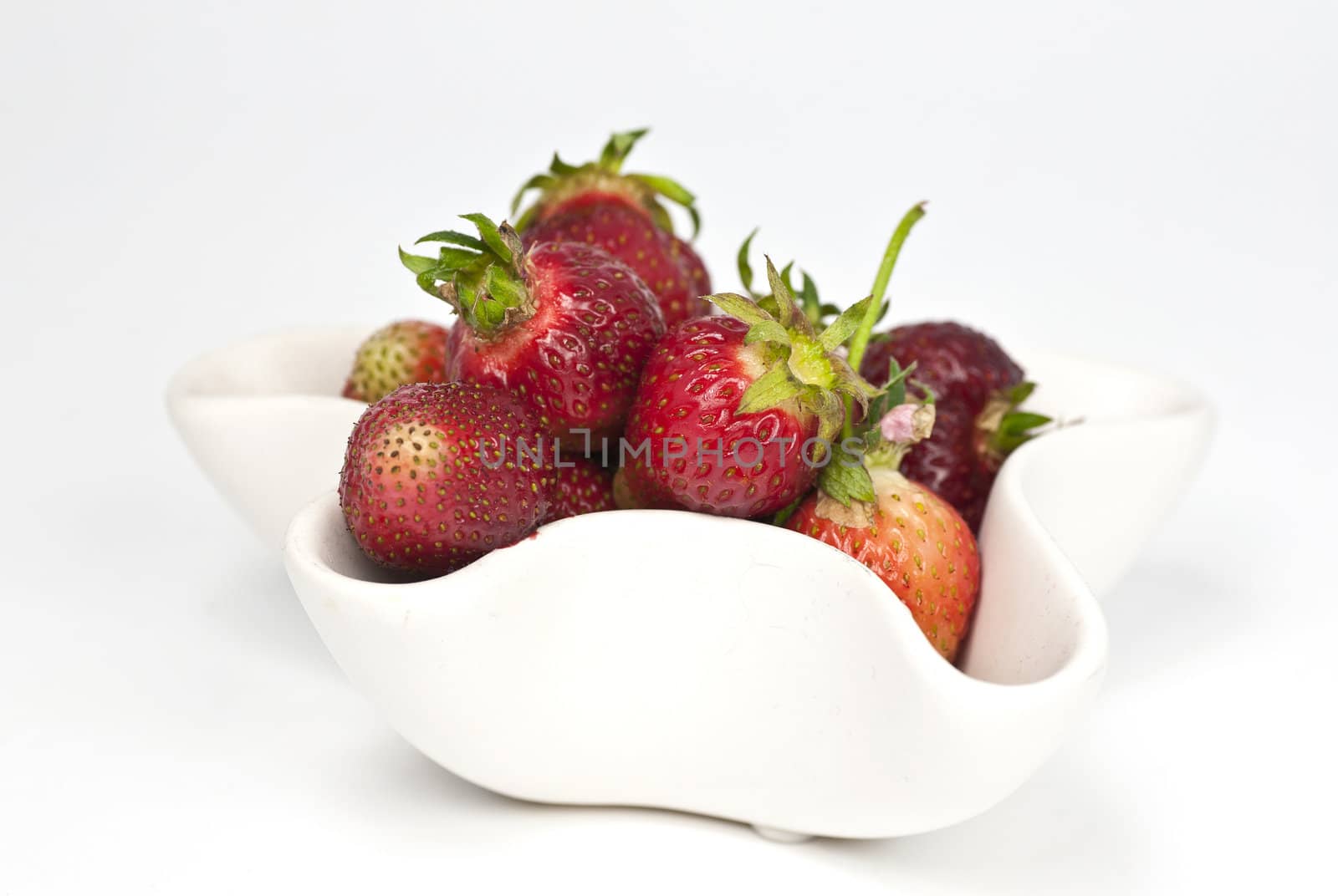 A bowl full of freshly picked natural growned strawberries