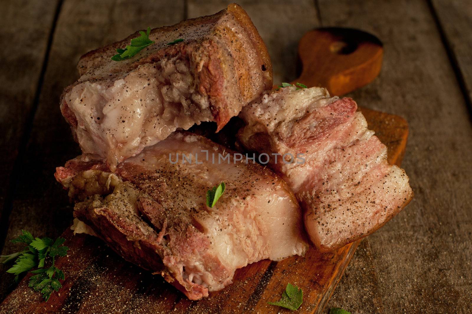 Baked meat with fat on the wooden table