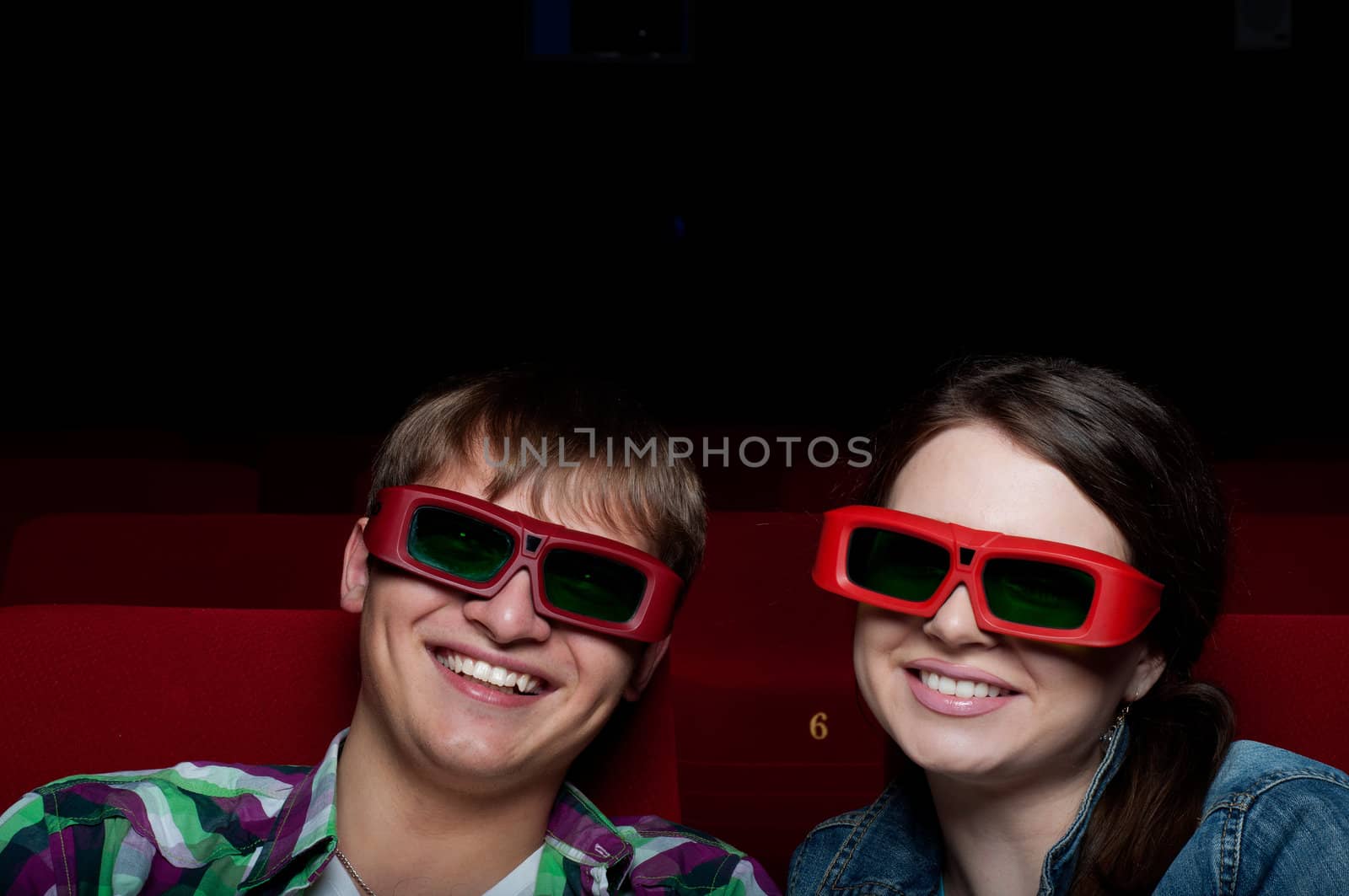 couple in a movie theater, watching a 3D movie