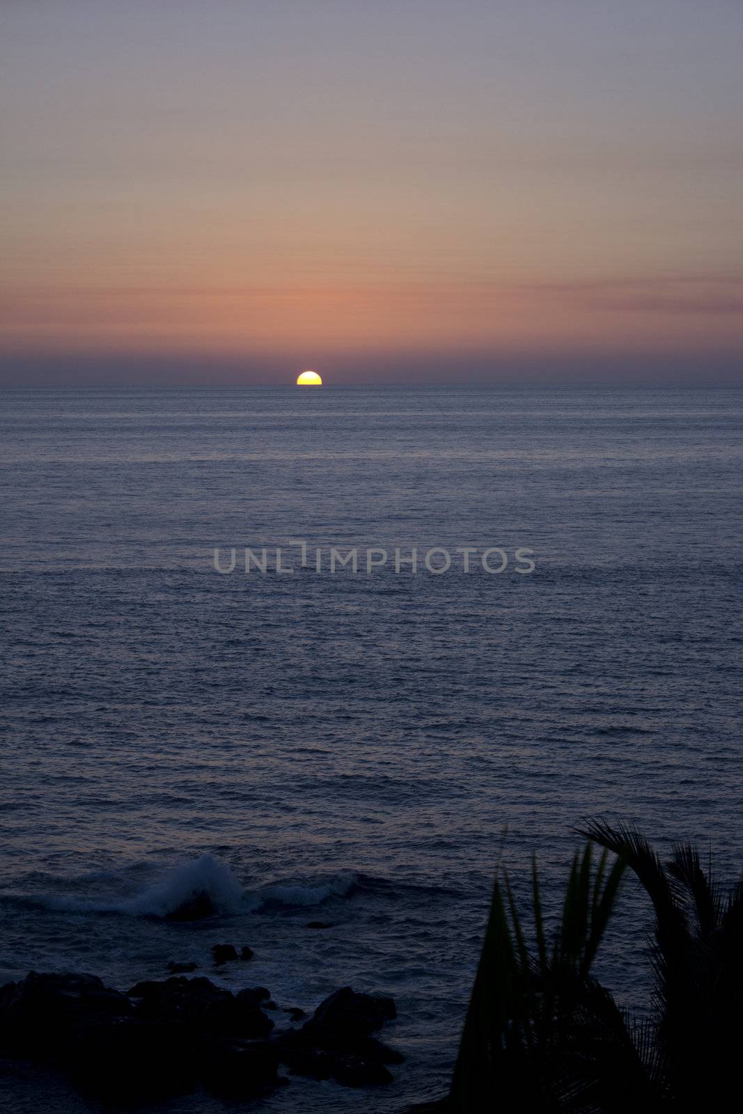 A tropical sunset over the ocean by jeremywhat