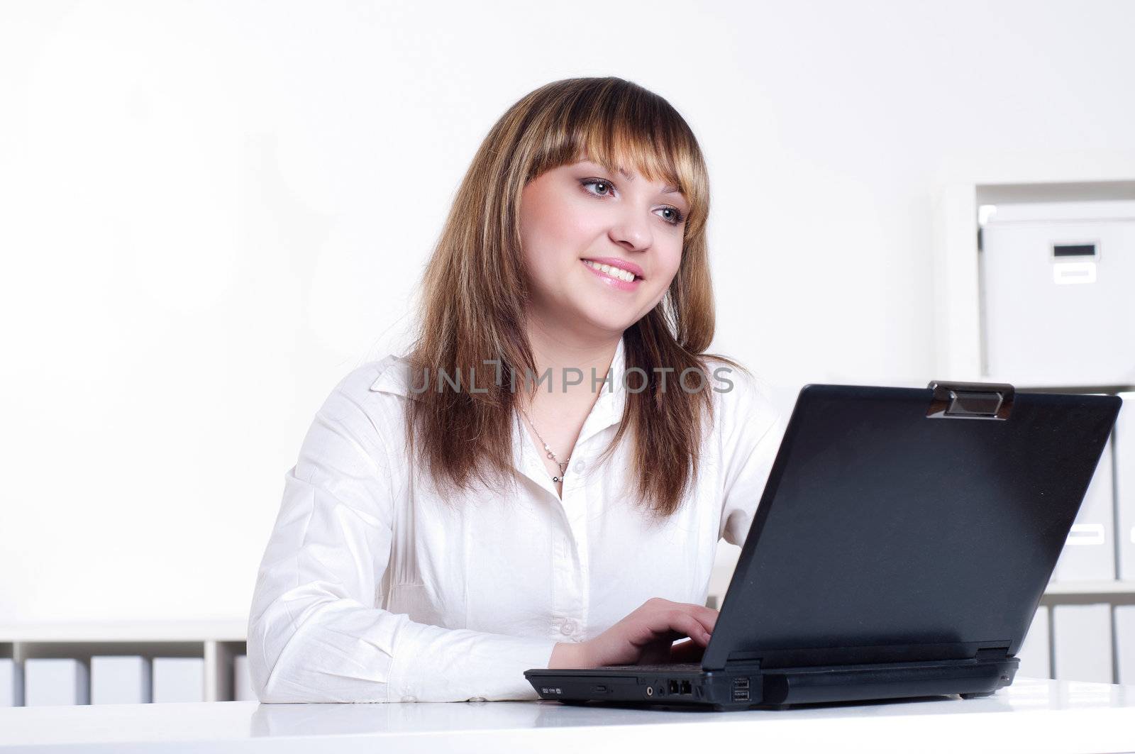 Young busines woman with notebook, in office