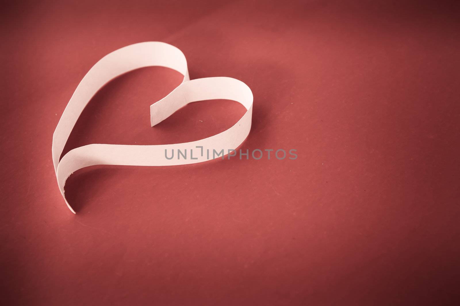 Paper heart on red background