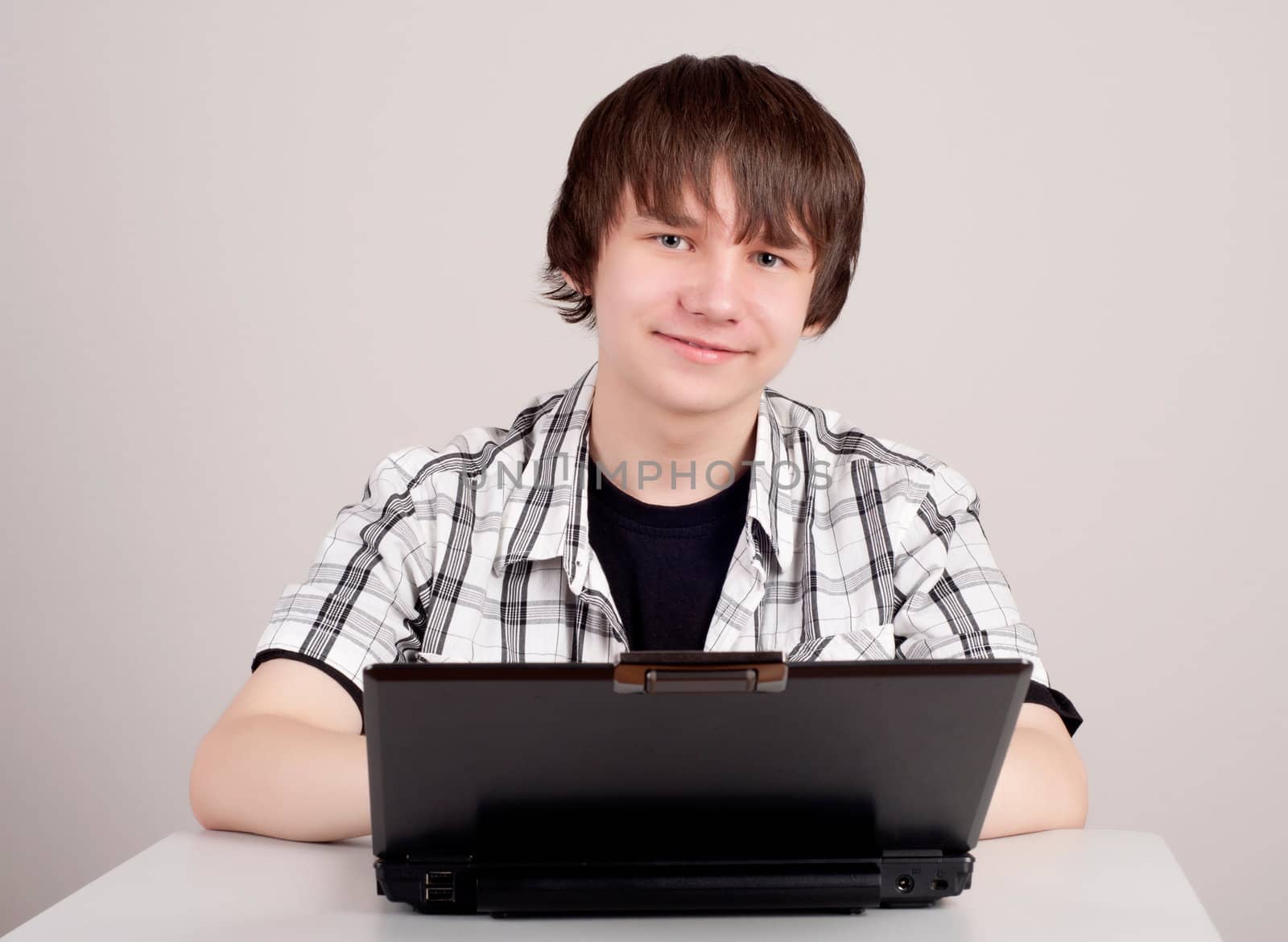 student sits for a portable computer by adam121