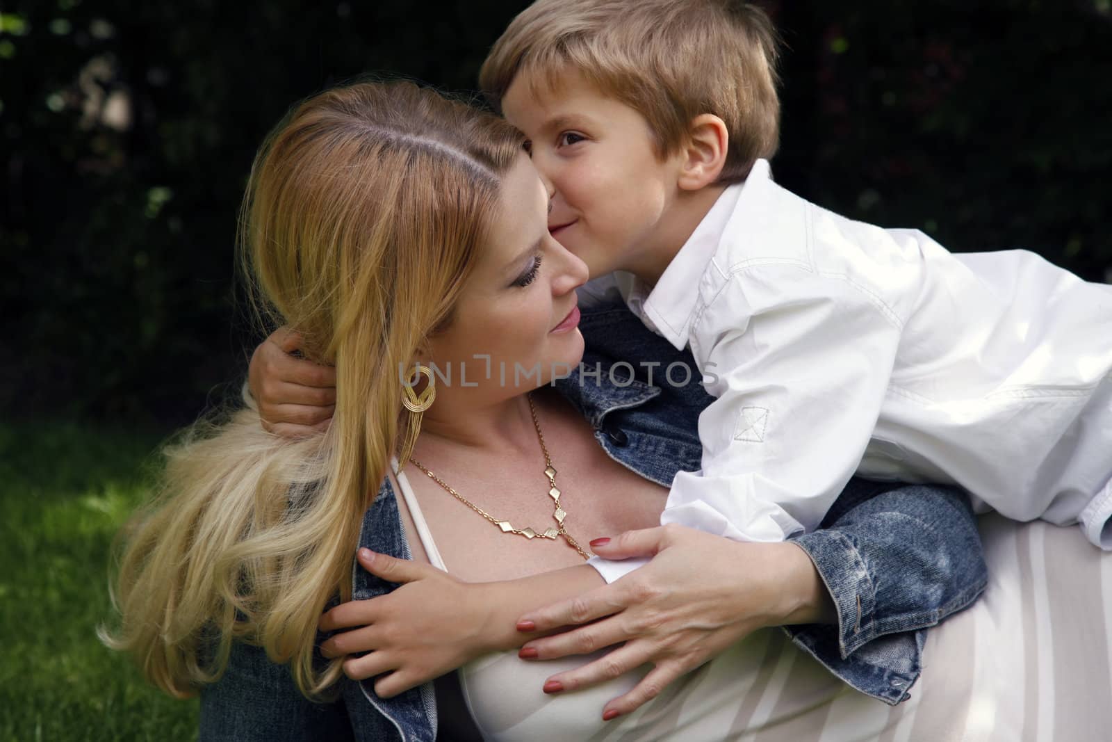 Portrait of beautiful happy smiling mather with son outdoor, on nature