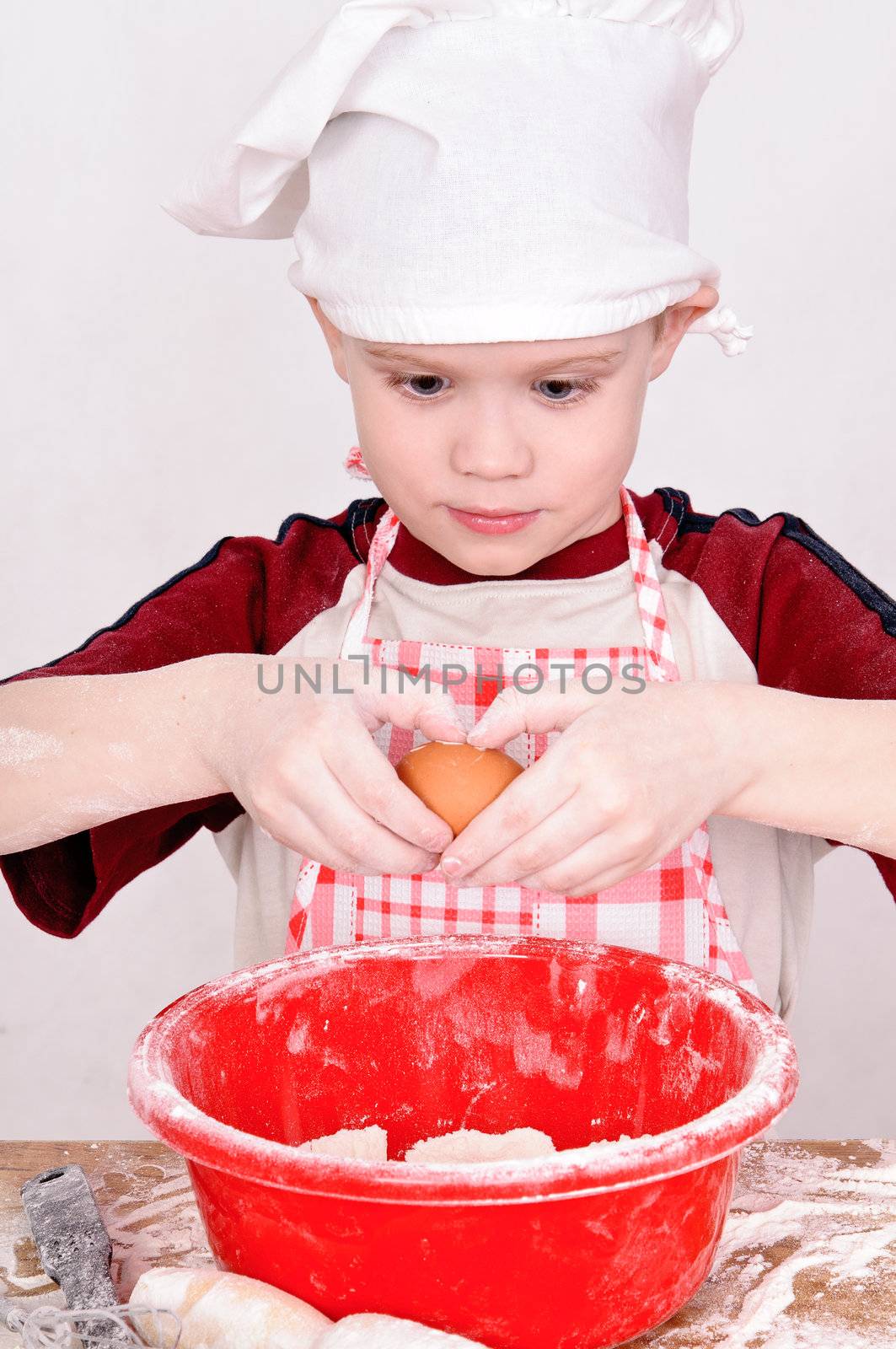 boy in chef hat knead the dough