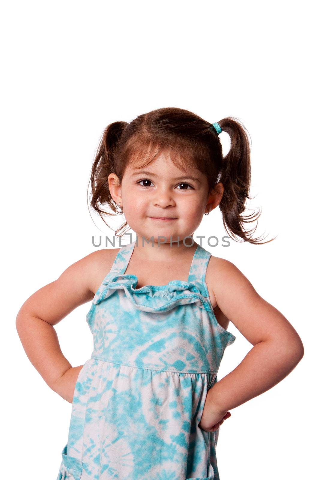 Cute little young toddler girl with attitude smirk, hands on hips and pigtails in hair, isolated.