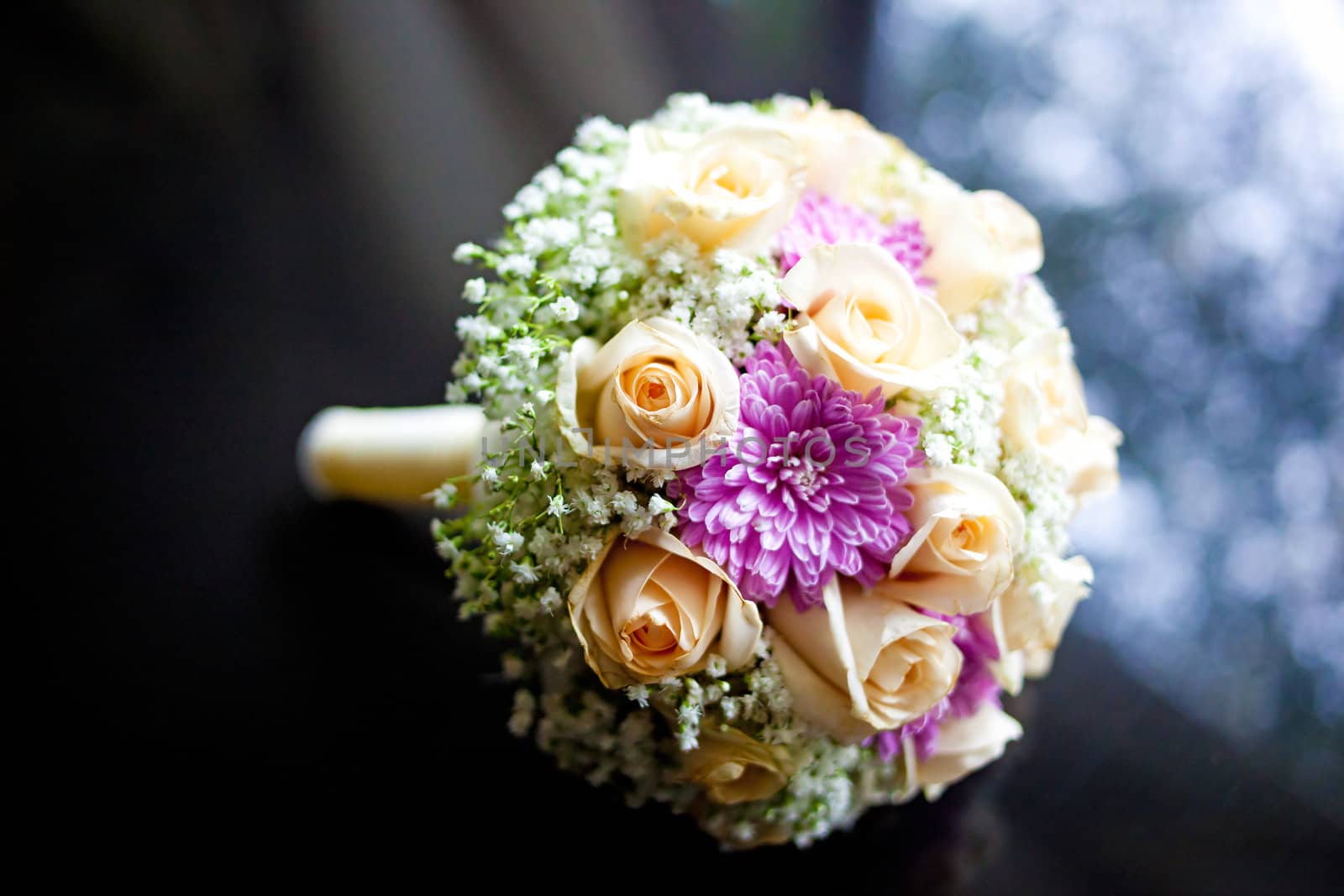 Beautiful wedding bouquet on the black table with bokeh