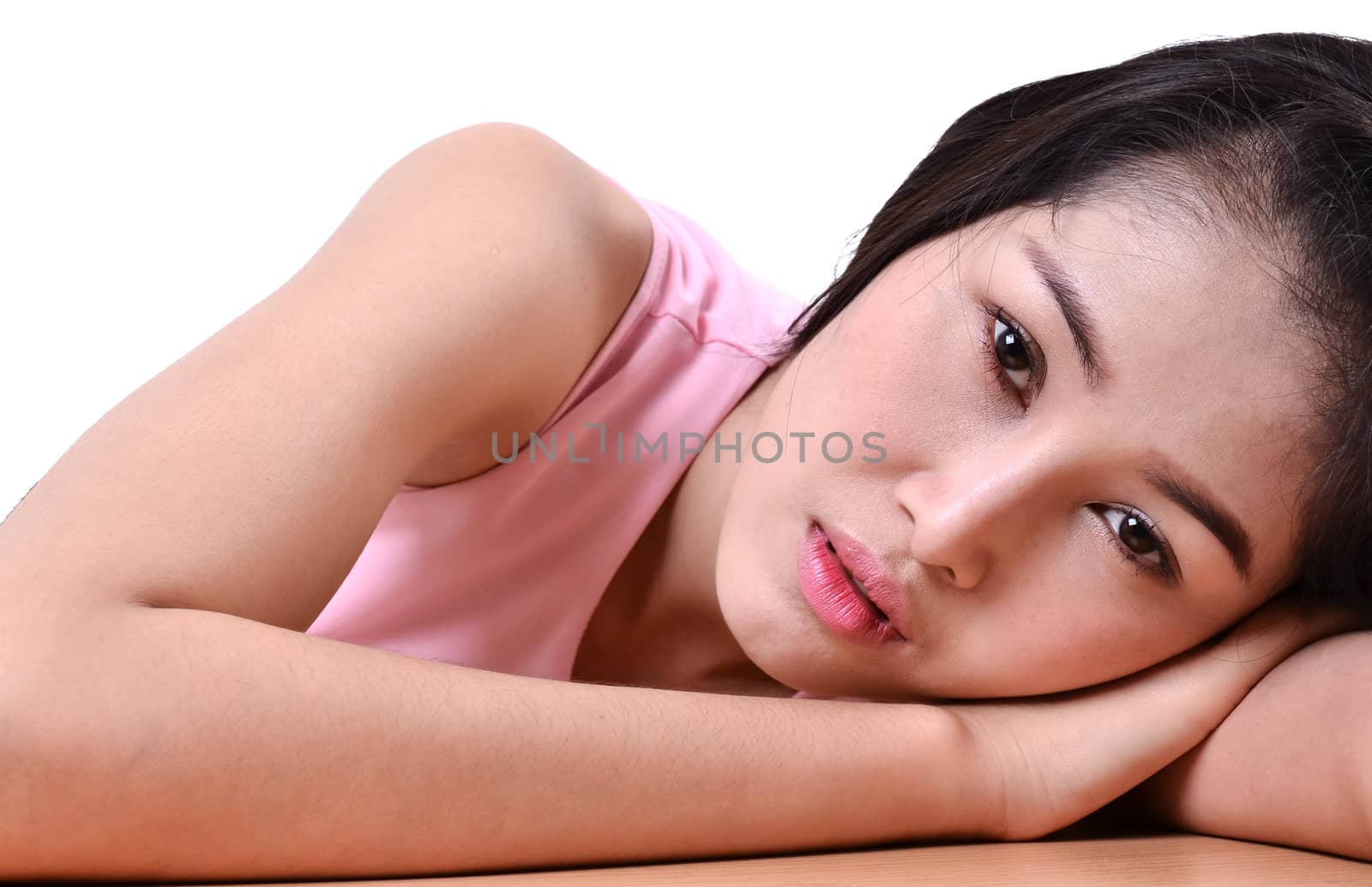 Sad beautiful woman standing against a white background