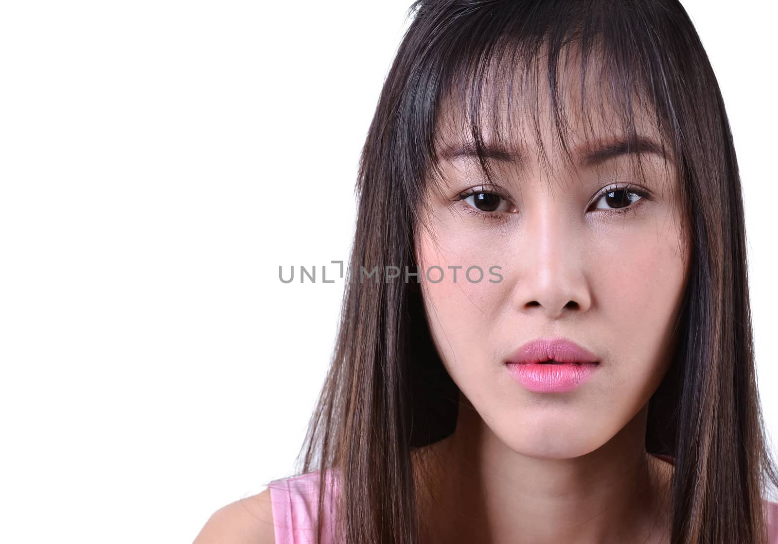 Sad beautiful woman standing against a white background