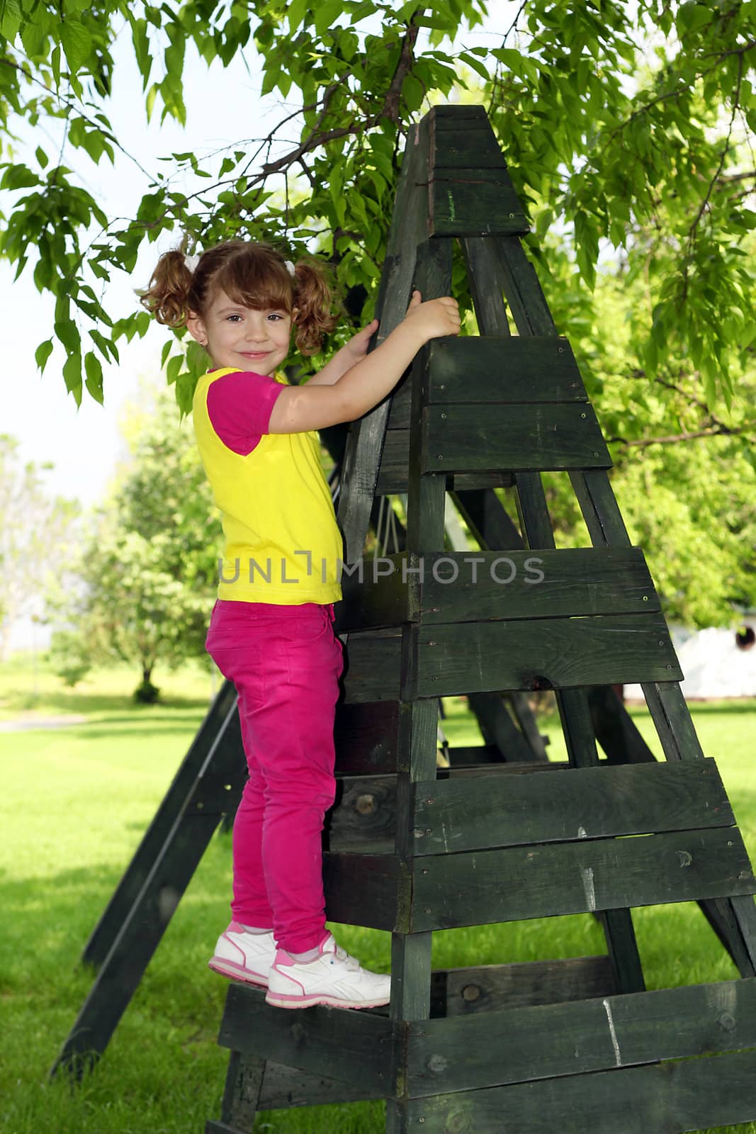 little girl on playground posing