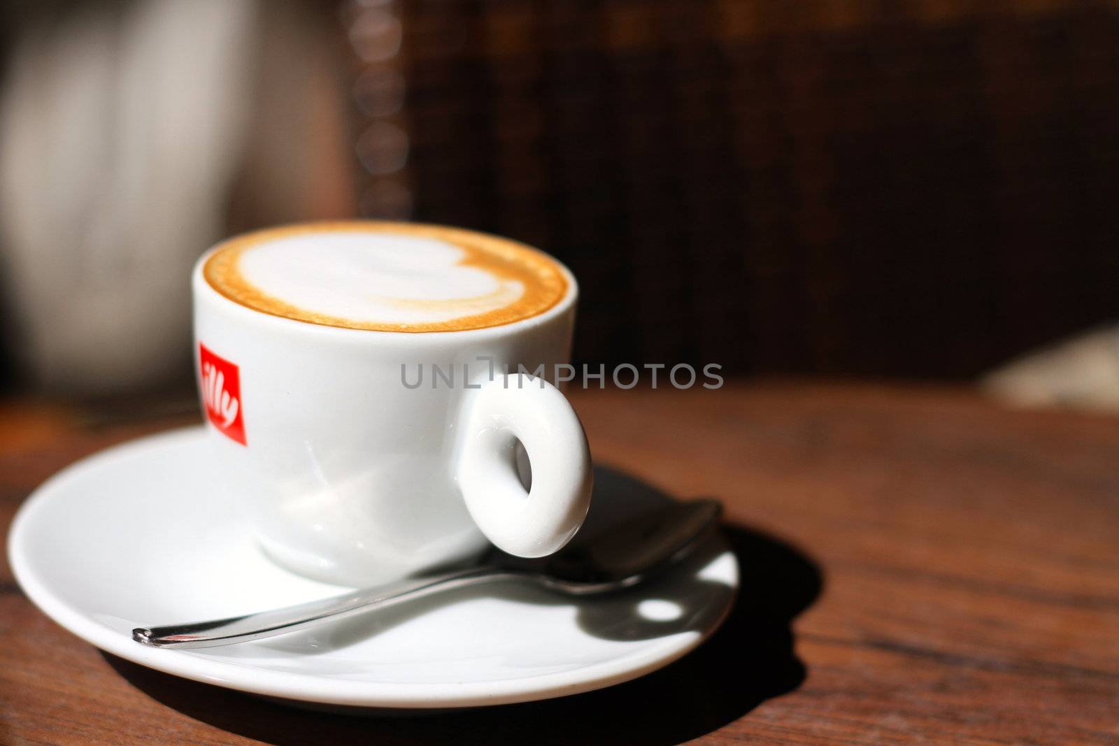 Illy coffee cup on the table of an italian bar. Hungarian born Francesco Illy first came to Trieste, Italy after World War I. There he studied economics, and he returned and found a business in cocoa and coffee wich would become its sole focus.