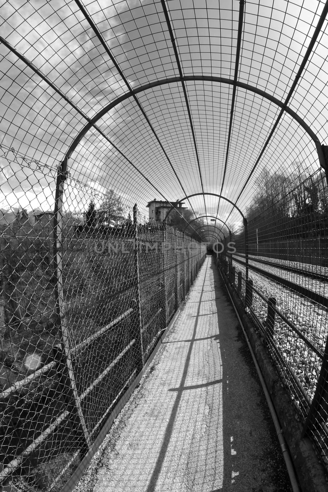 long pedestrian tunnel near by the train railway in Belluno