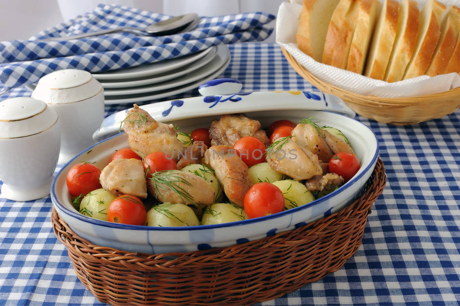 Baked potatoes with dill and chicken and tomatoes