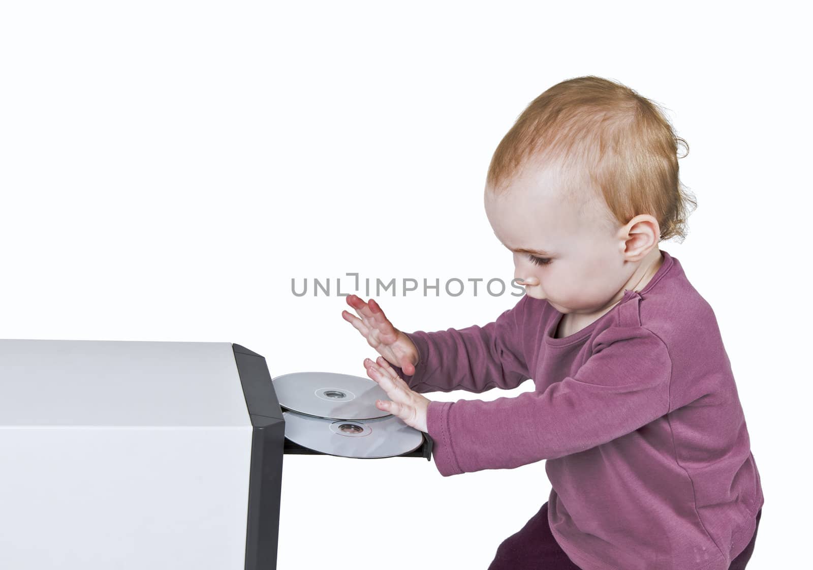 young child playing with CD and computer - isolated on white background