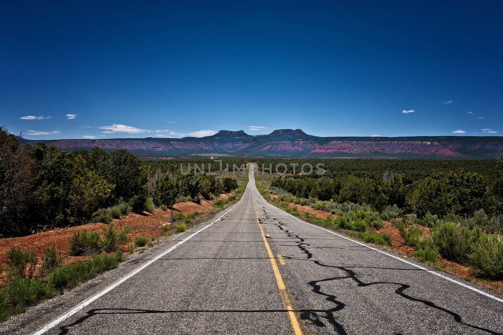 Image of a long desolate road leading off into a plateau