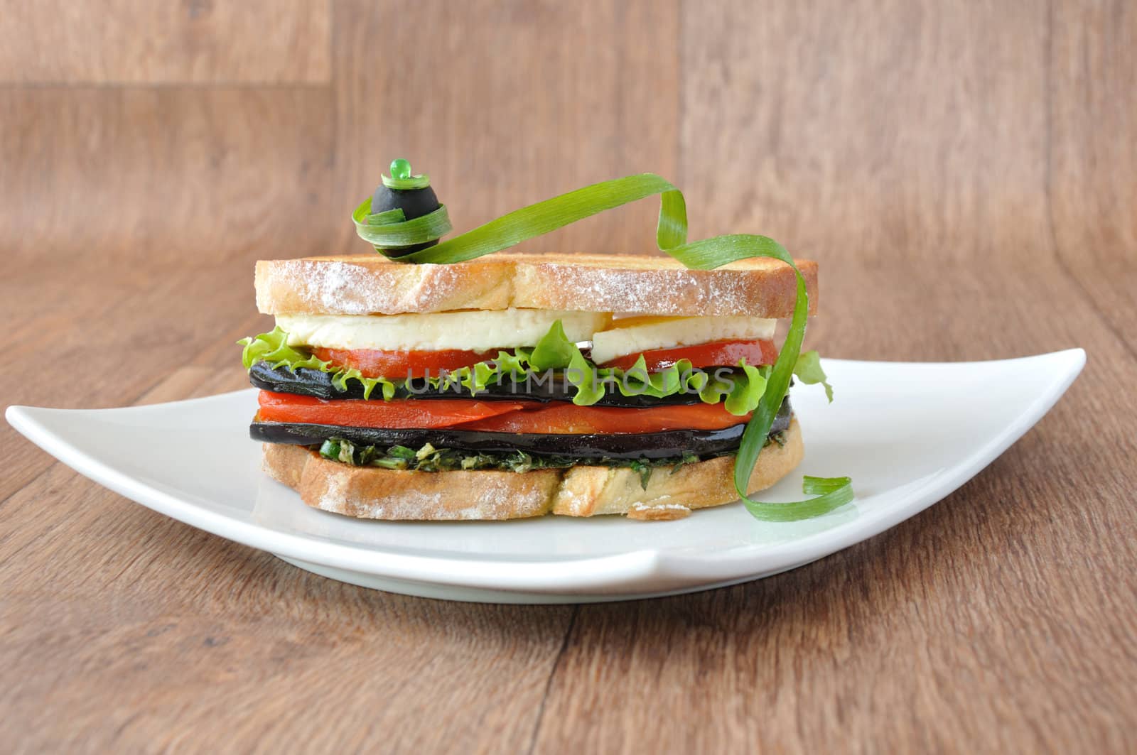  Sandwich with eggplant, tomatoes, peppers and cheese