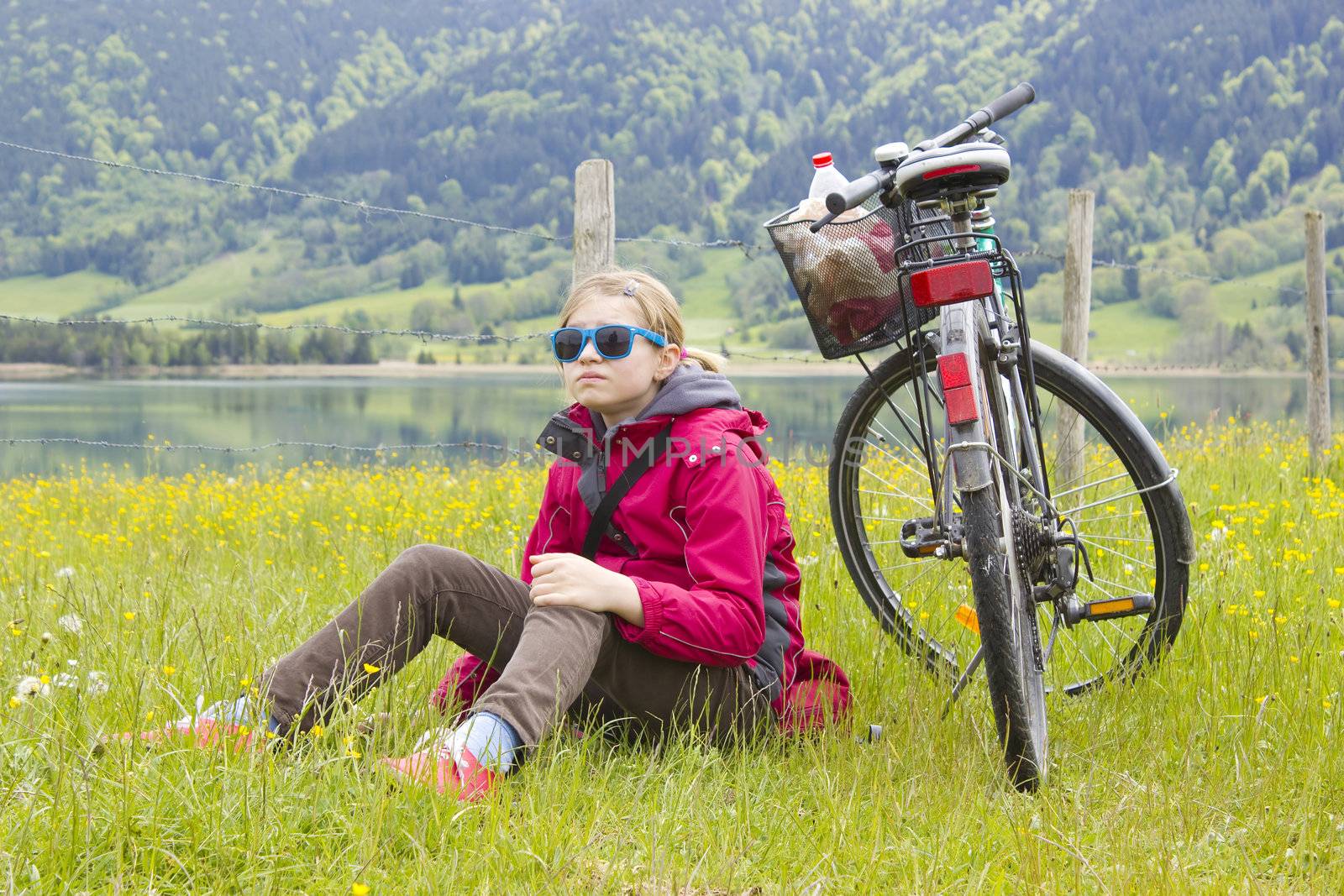 young girl with the bike in the mountains by miradrozdowski