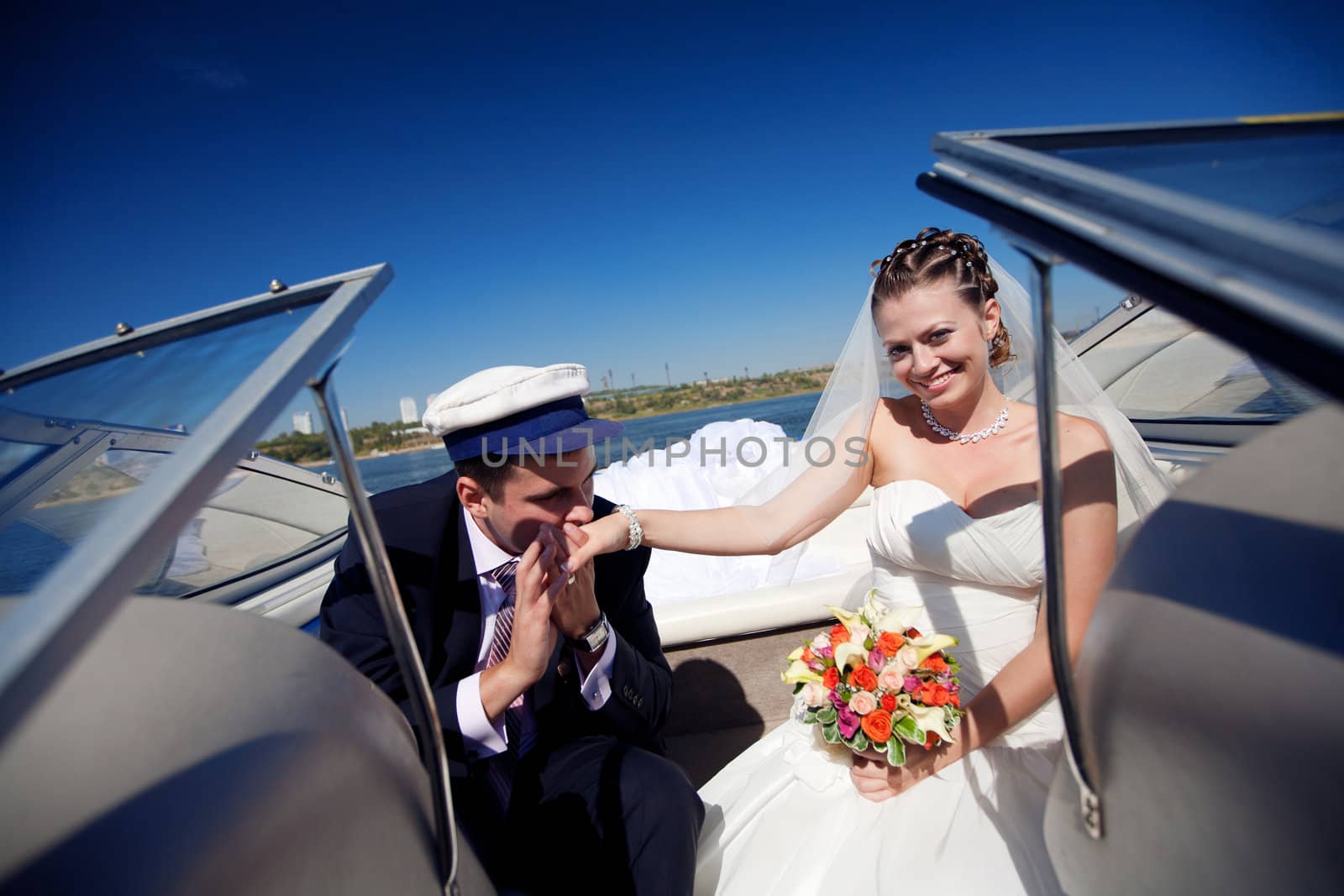 captain kissing hand to a lady on the yacht