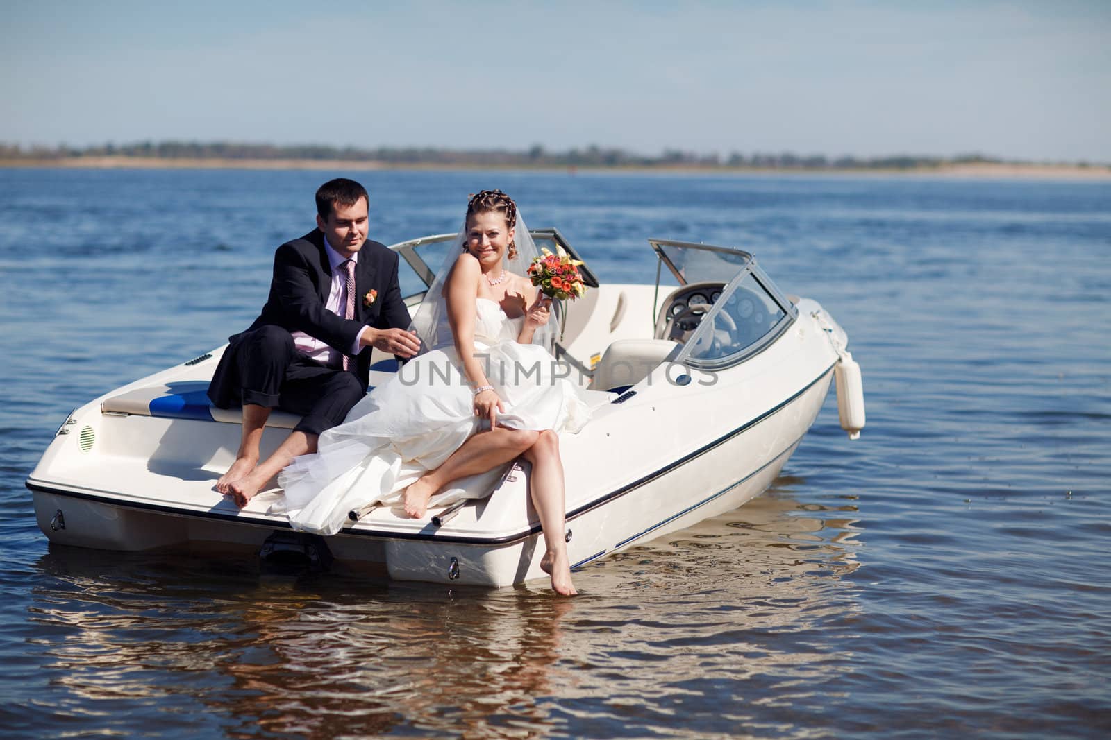 happy young couple having picnic on the yacht