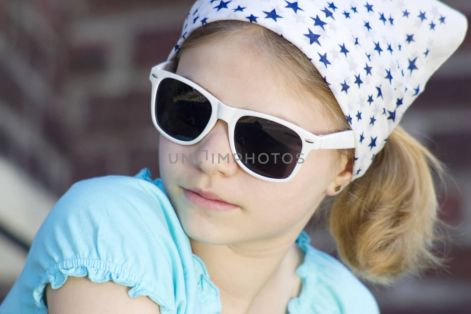 portrait of a cute little girl wearing sunglasses by miradrozdowski
