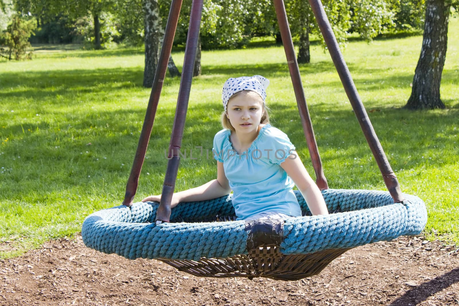 Young girl on swing in the park  by miradrozdowski