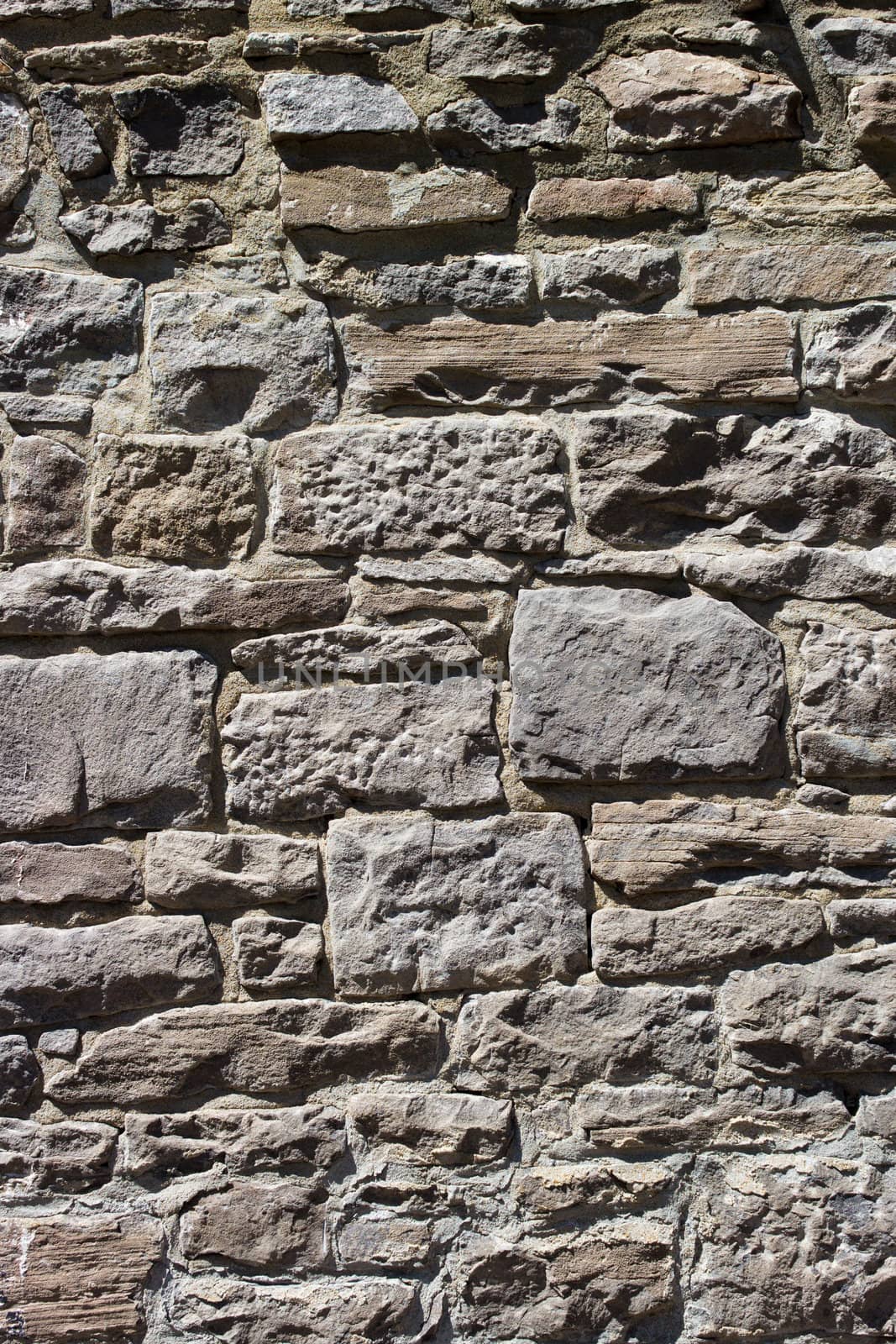 Old wall with irregular pattern of stone - background.