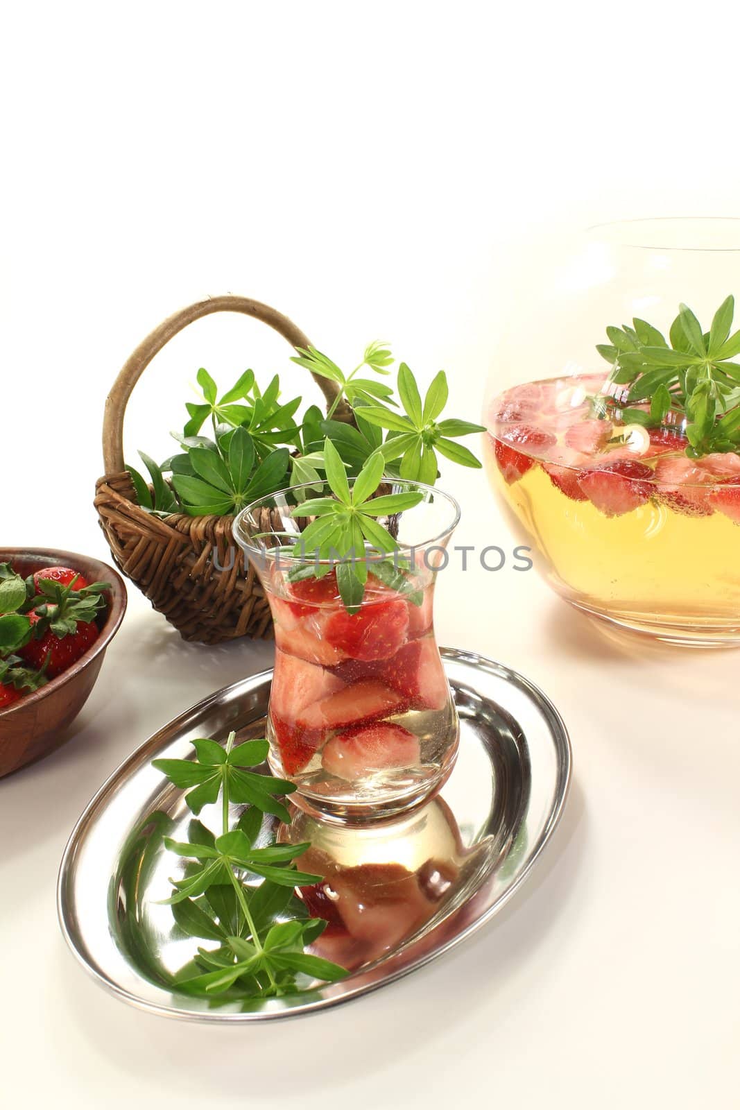 May wine with strawberries and fresh woodruff on a light background