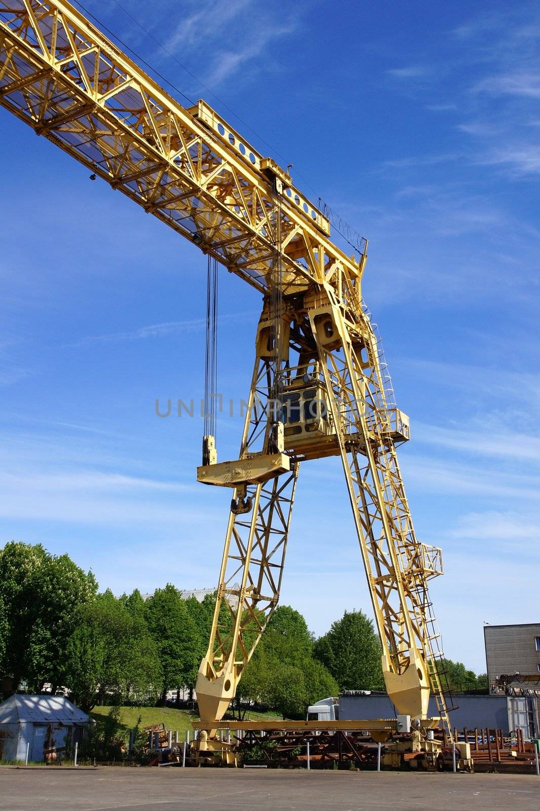 The industrial crane on a background of the blue sky