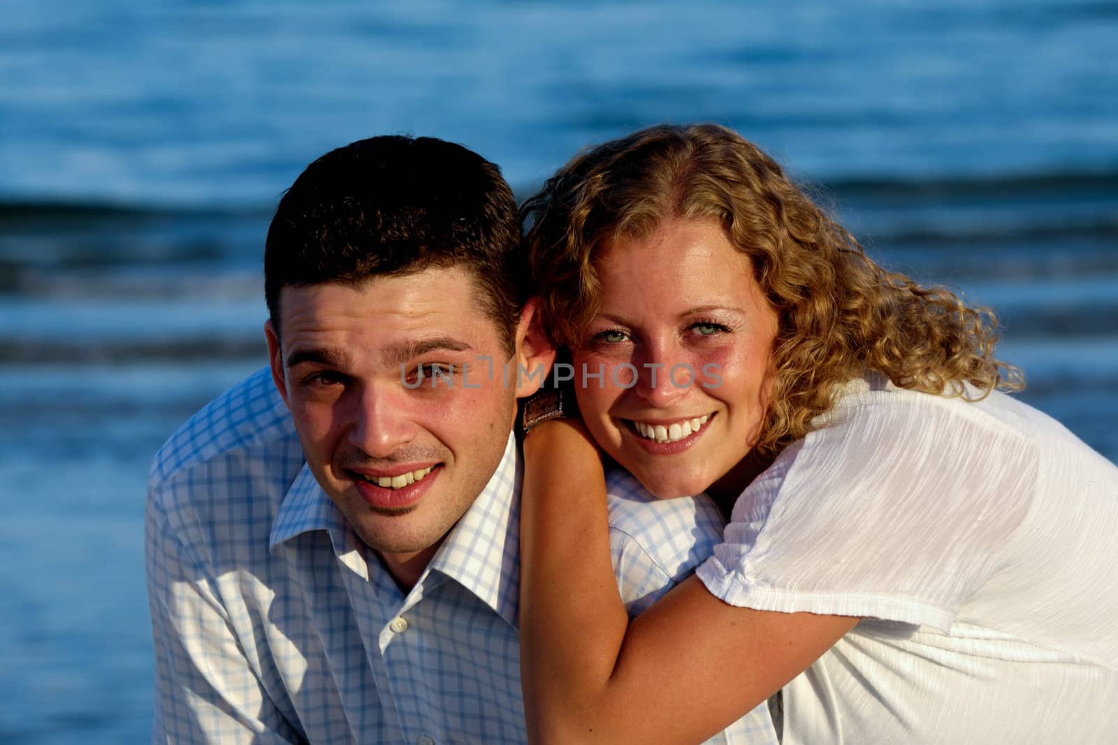 A happy woman and man in love at beach.