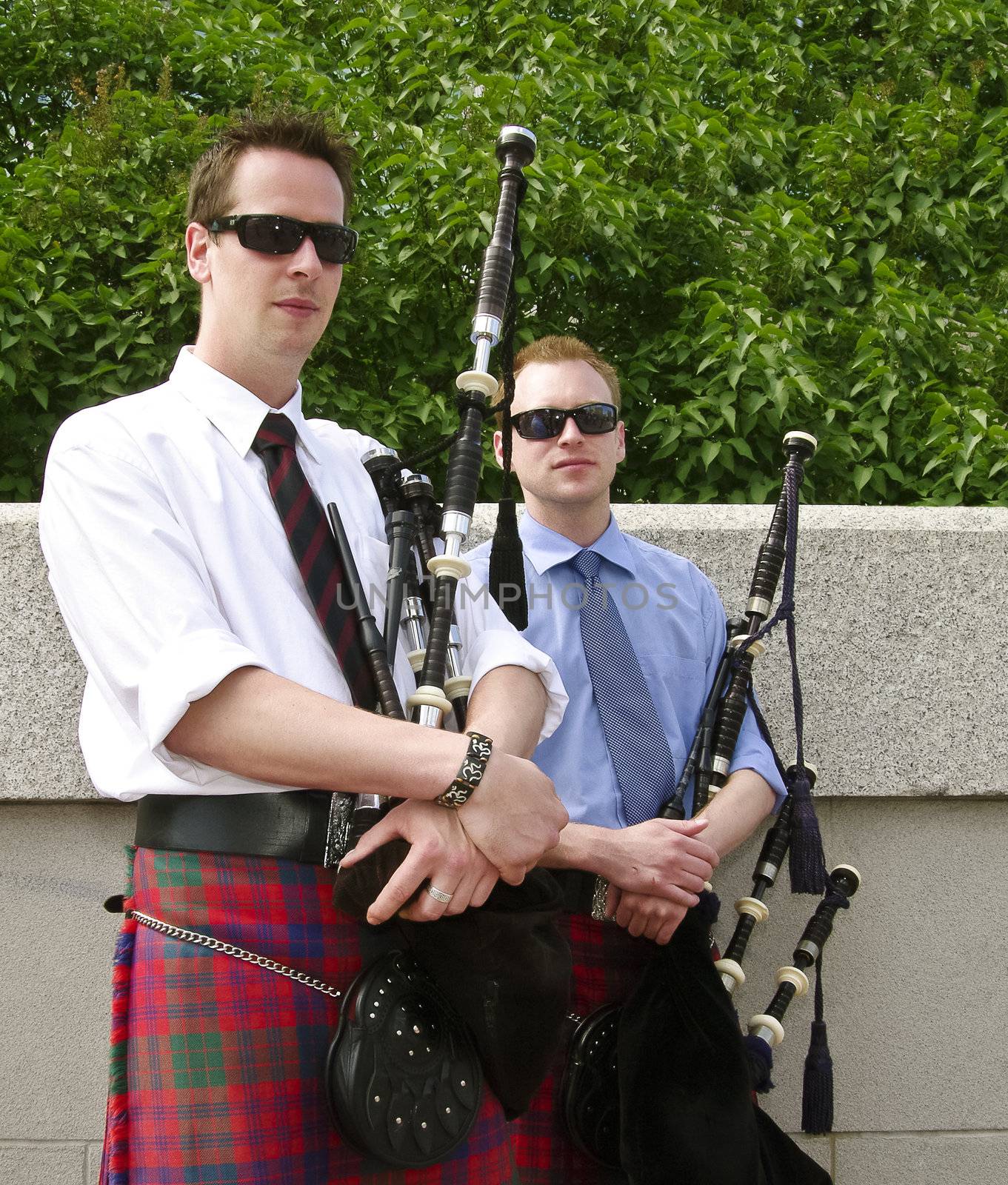Bagpipe duo relaxing between songs as they entertain tourists in Ottawa, Canada.