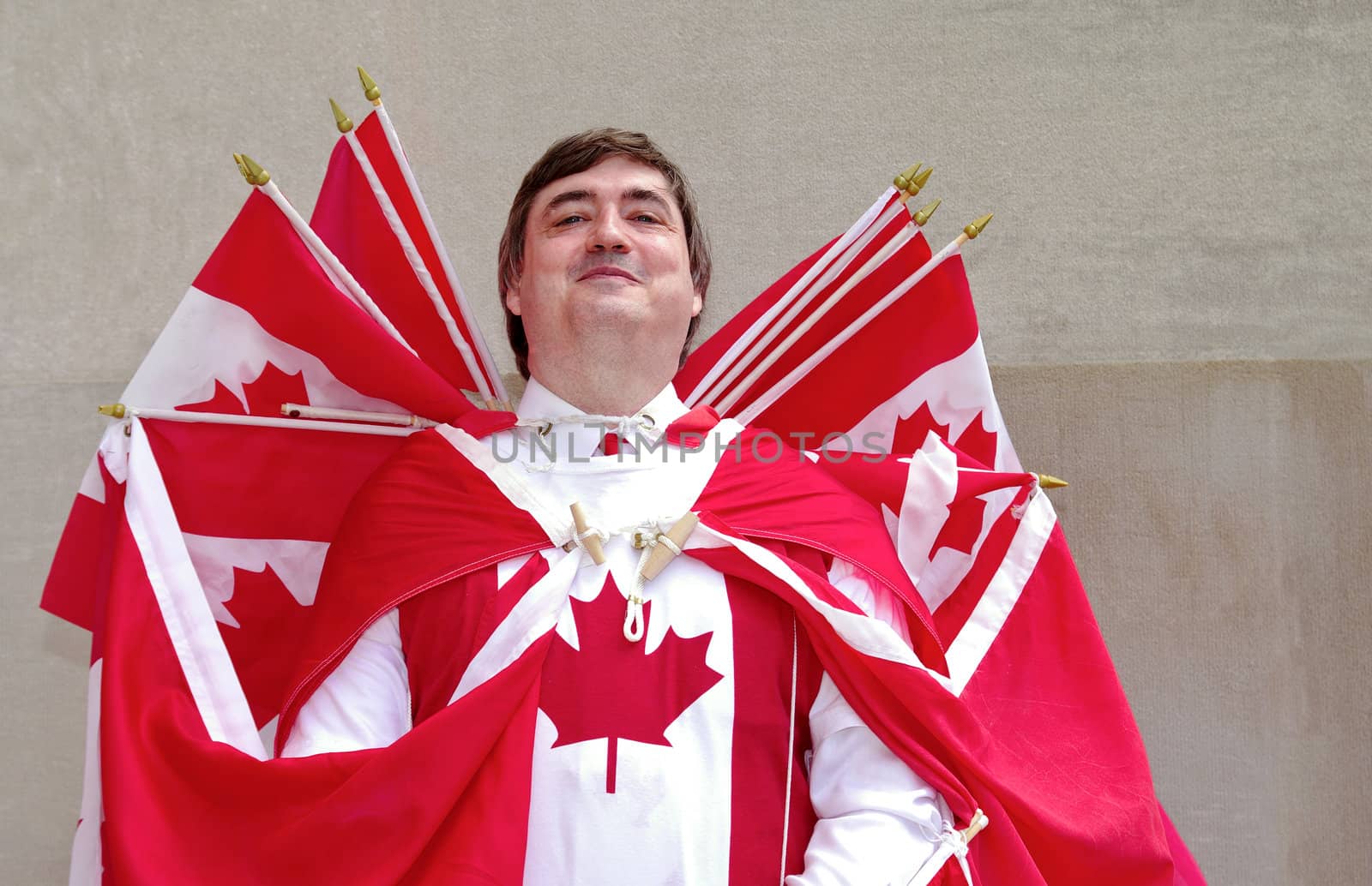 Celebrating Canada Day, a man is dressed with canadian flags.