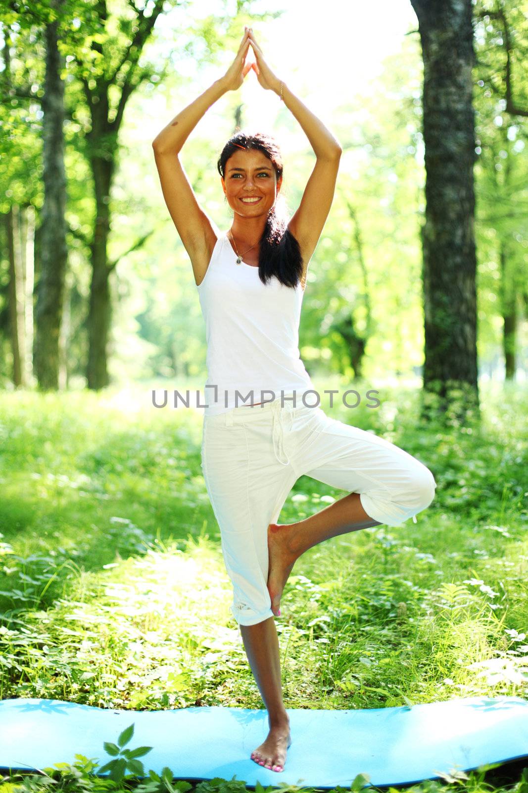 yoga woman on green grass in forest