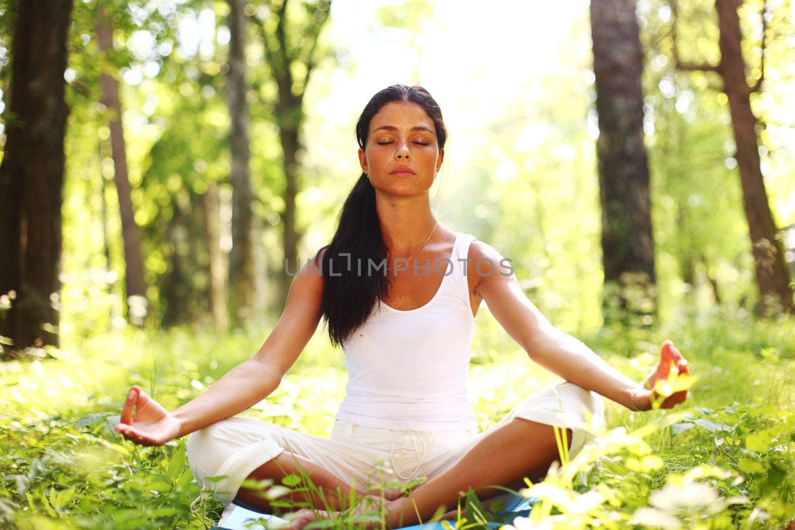 yoga woman on green grass in forest