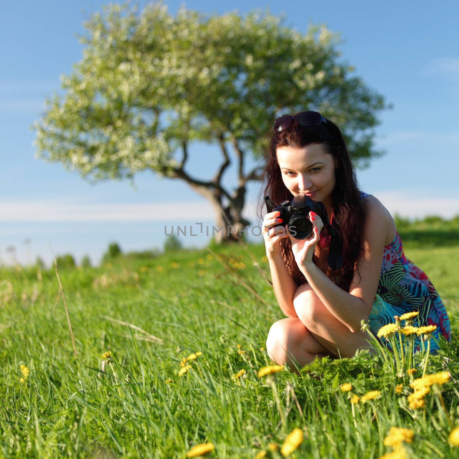 woman photographer on green grass field