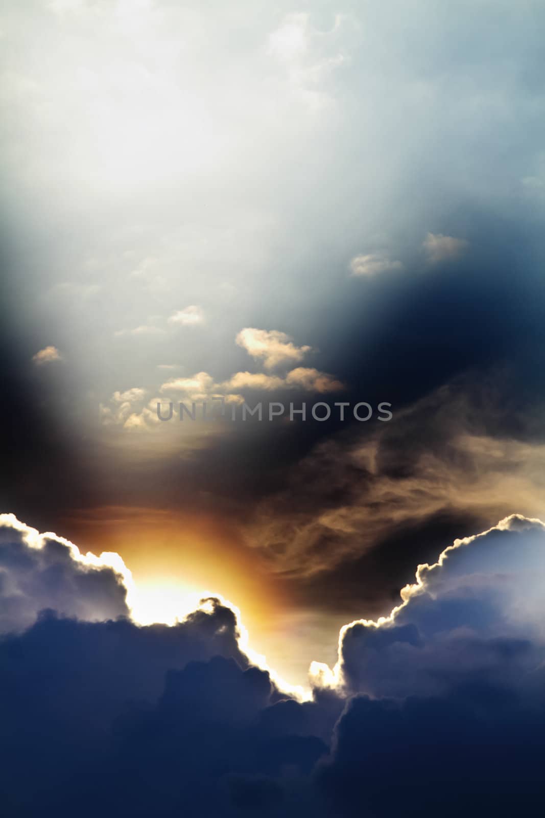 View of clouds in blue sky with rays of light