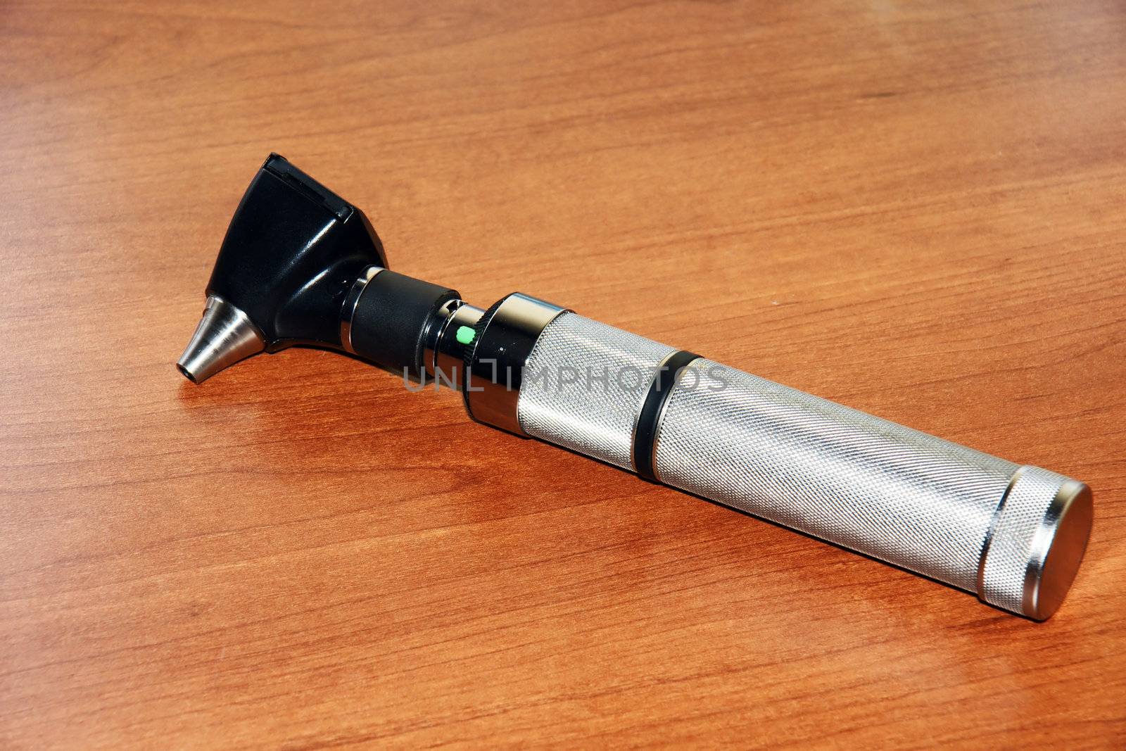 Otoscope on wooden table by Mirage3