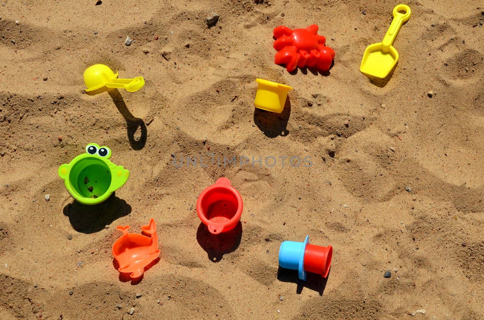 Various children's toys on the sand