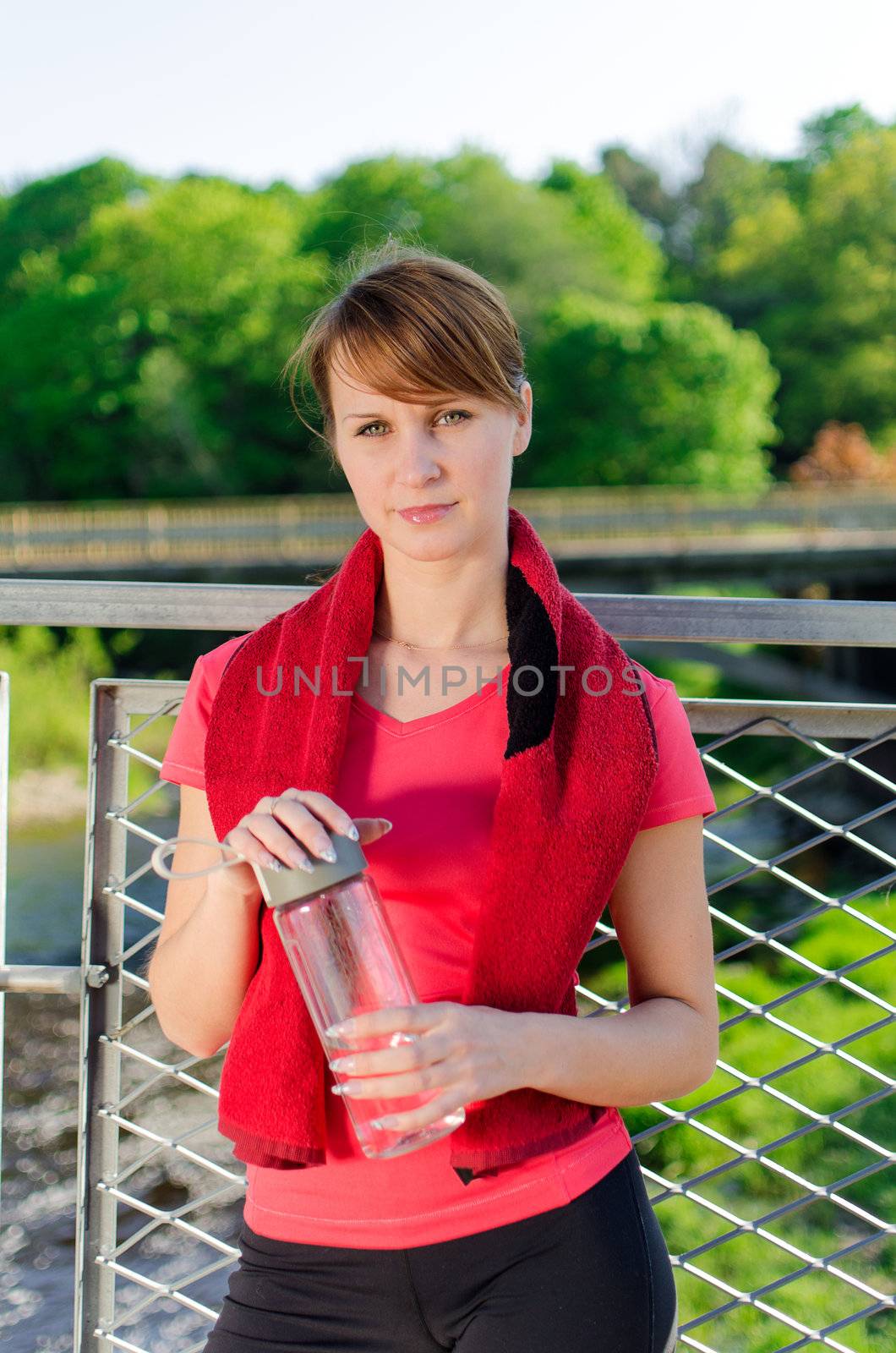 Portrait of female runner with bottle of water