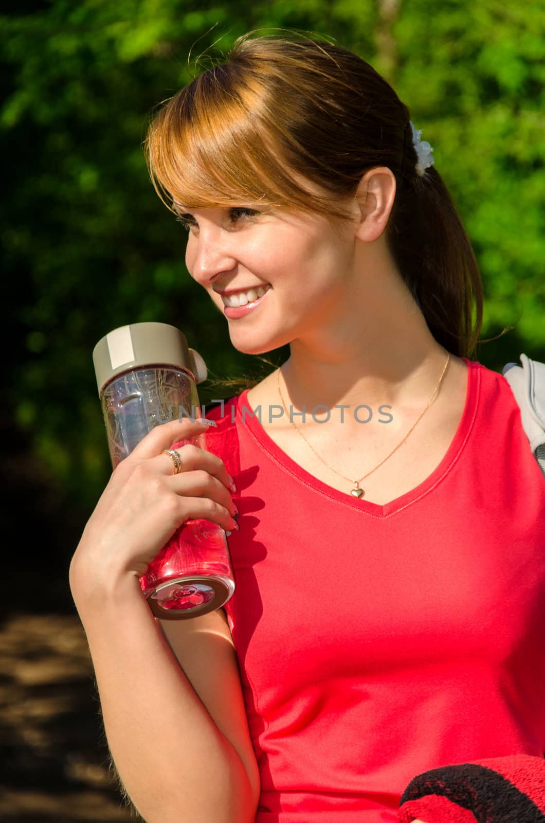 Portrait of female runner with bottle of water