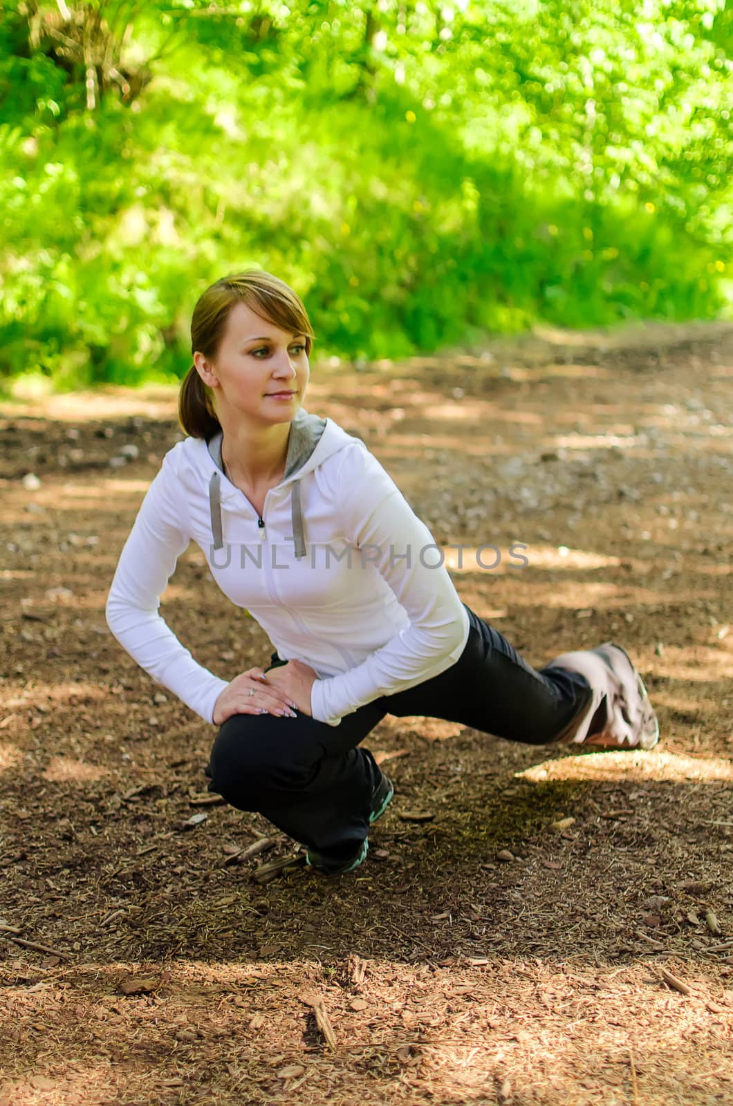 Attractive young woman stretching before Run
