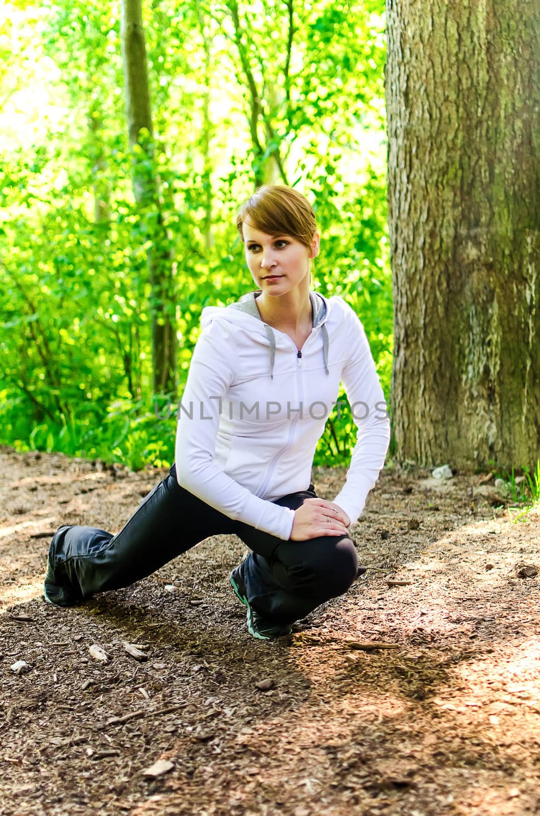 Attractive young woman stretching before Run