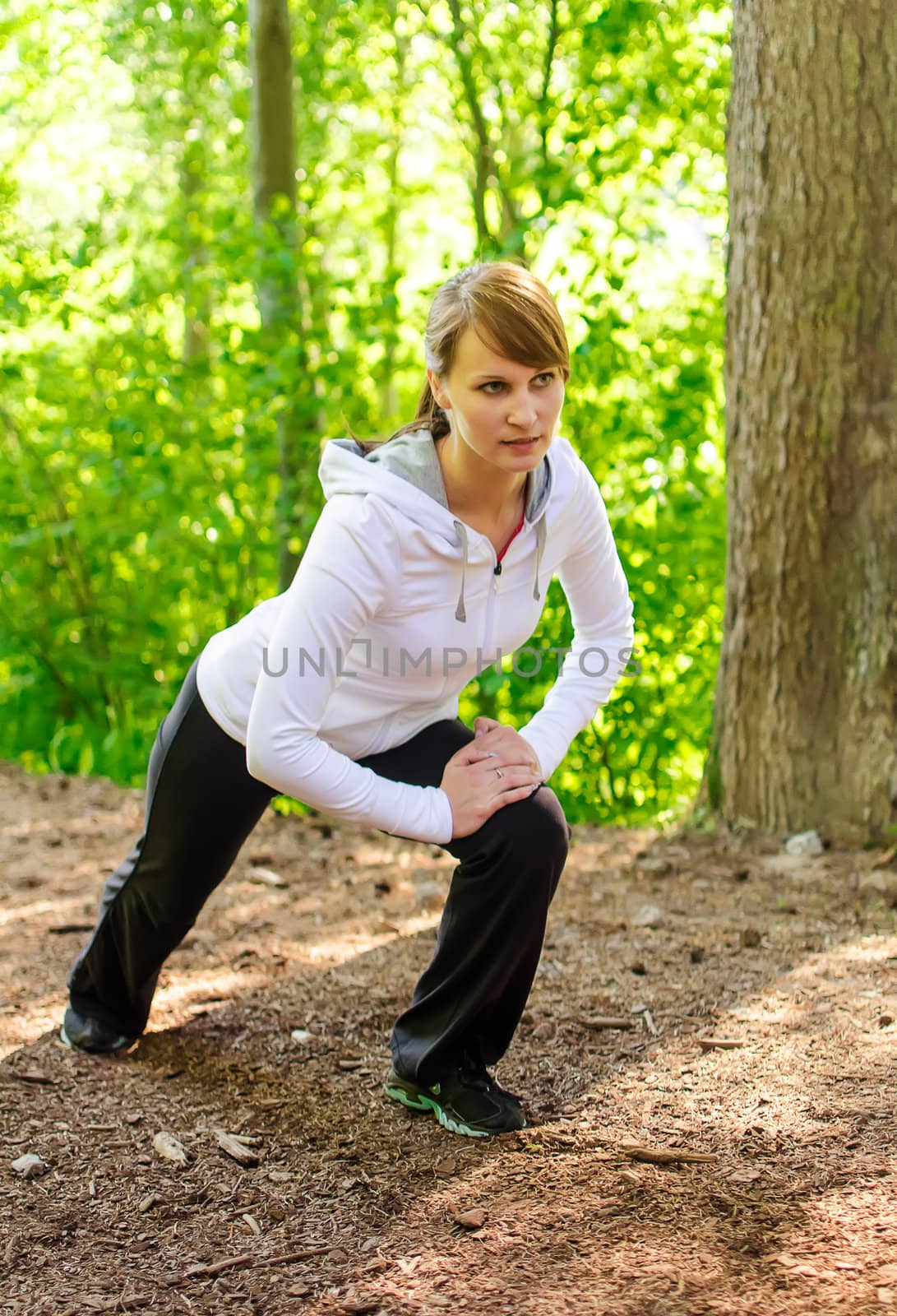 Attractive young woman stretching before Run