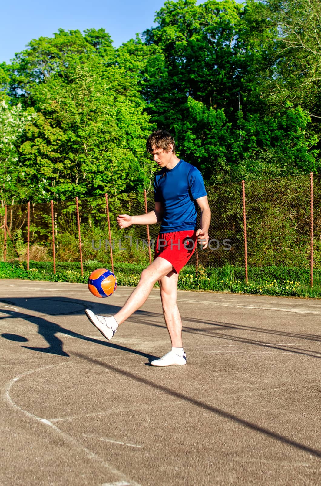 Guy is training with the ball on the court