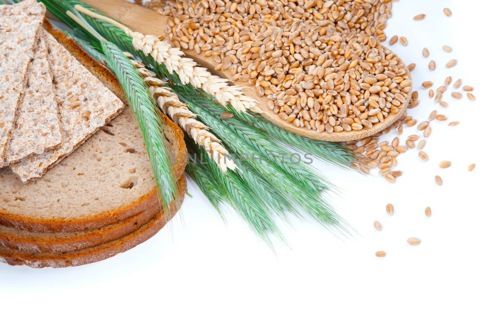 tasty baked bread with ears and wheat grain, isolated on a white background